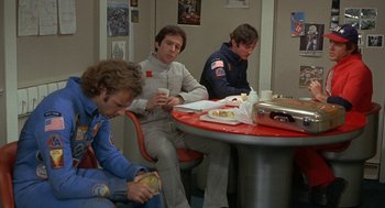 Movie still from “Silent Running” (1972), directed by Douglas Trumbull – A group of men sitting at a table eating food; Medium shot, High angle