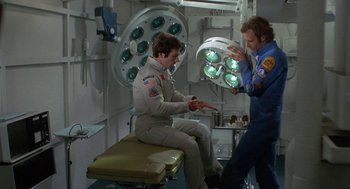 Movie still from “Silent Running” (1972), directed by Douglas Trumbull – Two men in a room with a surgical light; Medium shot, Overhead angle