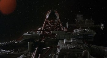 Movie still from “Silent Running” (1972), directed by Douglas Trumbull – A tall building with a sky background at night; Extreme Wide shot, Overhead angle