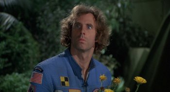 Movie still from “Silent Running” (1972), directed by Douglas Trumbull – A person wearing a suit holding a flower; Close Up shot, Low angle