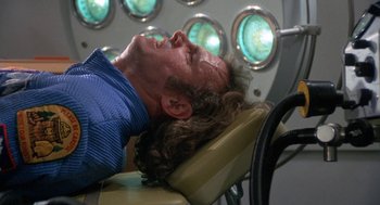 Movie still from “Silent Running” (1972), directed by Douglas Trumbull – A man is lying down on a dental chair; Close Up shot, Overhead angle
