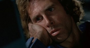 Movie still from “Silent Running” (1972), directed by Douglas Trumbull – A person with his head resting on his hand; Close Up shot, Low angle