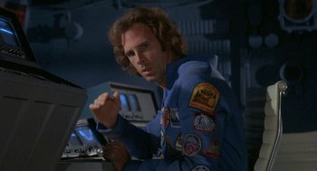 Movie still from “Silent Running” (1972), directed by Douglas Trumbull – A man in a blue shirt is holding a pen; Close Up shot, Low angle