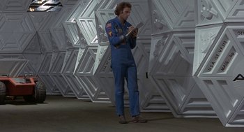 Movie still from “Silent Running” (1972), directed by Douglas Trumbull – A man standing in a room full of white walls; Wide shot, Low angle