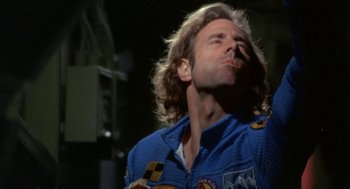 Movie still from “Silent Running” (1972), directed by Douglas Trumbull – A person with long hair smoking a cigarette; Close Up shot, Low angle