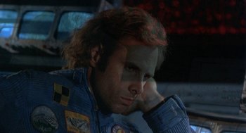 Movie still from “Silent Running” (1972), directed by Douglas Trumbull – A man sitting in a car with his hand under his chin; Close Up shot, High angle