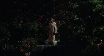 Movie still from “Silent Running” (1972), directed by Douglas Trumbull – A woman in a white robe standing in front of trees; Wide shot, Low angle