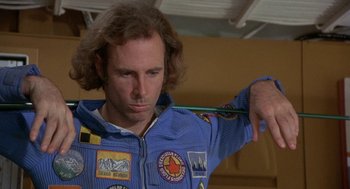 Movie still from “Silent Running” (1972), directed by Douglas Trumbull – A man in a space suit holding a pencil; Close Up shot, Low angle