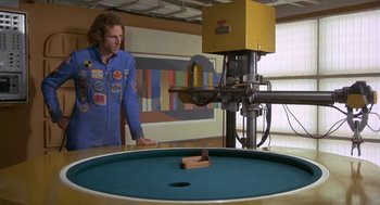 Movie still from “Silent Running” (1972), directed by Douglas Trumbull – A man standing in front of a machine; Wide shot, High angle