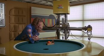 Movie still from “Silent Running” (1972), directed by Douglas Trumbull – A man in a blue spacesuit looking at an object; Wide shot, High angle