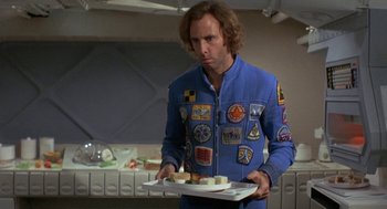 Movie still from “Silent Running” (1972), directed by Douglas Trumbull – A man in a space suit holding a tray of food; Medium shot, Low angle