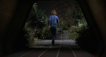 Movie still from “Silent Running” (1972), directed by Douglas Trumbull – A person walking on a path in a tunnel; Wide shot, High angle