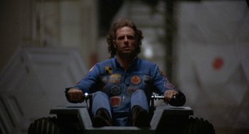 Movie still from “Silent Running” (1972), directed by Douglas Trumbull – A man sitting on top of a motorcycle; Medium shot, Low angle