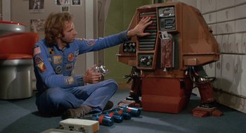 Movie still from “Silent Running” (1972), directed by Douglas Trumbull – A man sitting on the floor playing a video game; Medium shot, Overhead angle