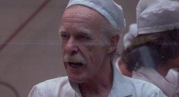 Movie still from “Silkwood” (1983), directed by Mike Nichols – An older man with a beard and a white hat; Close Up shot, Low angle