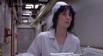 Movie still from “Silkwood” (1983), directed by Mike Nichols – A woman in a white lab coat and a white hat; Close Up shot, Low angle
