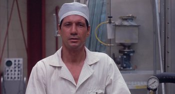 Movie still from “Silkwood” (1983), directed by Mike Nichols – A man in a white shirt and a white hat; Close Up shot, Low angle