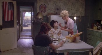 Movie still from “Silkwood” (1983), directed by Mike Nichols – Three women are sitting at a table in a kitchen; Wide shot, Over the shoulder angle