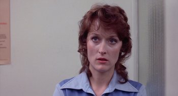 Movie still from “Silkwood” (1983), directed by Mike Nichols – A person wearing a blue shirt; Close Up shot, Over the shoulder angle