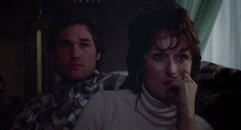 Movie still from “Silkwood” (1983), directed by Mike Nichols – A man and a woman sitting next to each other; Close Up shot, Over the shoulder angle