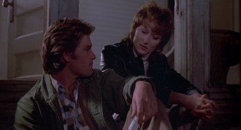 Movie still from “Silkwood” (1983), directed by Mike Nichols – A man and a woman sitting next to each other; Medium shot, Over the shoulder angle