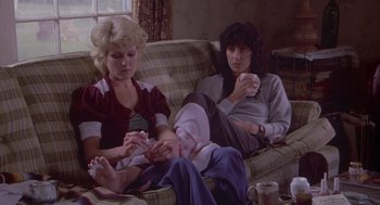 Movie still from “Silkwood” (1983), directed by Mike Nichols – Two women sitting on a couch drinking coffee; Medium shot, High angle