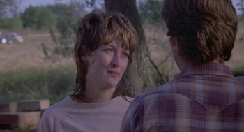 Movie still from “Silkwood” (1983), directed by Mike Nichols – A woman is looking at a man in a plaid shirt; Close Up shot, Over the shoulder angle