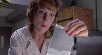 Movie still from “Silkwood” (1983), directed by Mike Nichols – A woman looking at a piece of paper in her hand; Close Up shot, Low angle
