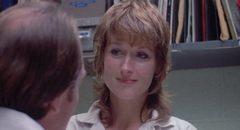 Movie still from “Silkwood” (1983), directed by Mike Nichols – A person looking at a person in a mirror; Close Up shot, Over the shoulder angle