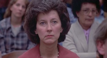 Movie still from “Silkwood” (1983), directed by Mike Nichols – An older woman with a serious look on her face; Close Up shot, Over the shoulder angle