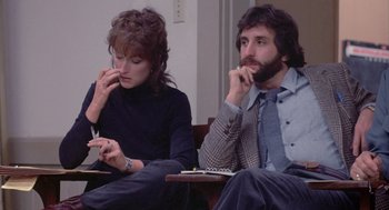 Movie still from “Silkwood” (1983), directed by Mike Nichols – A man and a woman sitting next to each other; Medium shot, Low angle