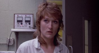 Movie still from “Silkwood” (1983), directed by Mike Nichols – A person wearing a white shirt; Close Up shot, Over the shoulder angle
