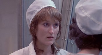 Movie still from “Silkwood” (1983), directed by Mike Nichols – A person wearing a hat; Close Up shot, Over the shoulder angle