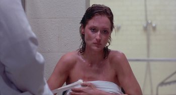 Movie still from “Silkwood” (1983), directed by Mike Nichols – A woman sitting in a bathroom holding a toothbrush; Close Up shot, Over the shoulder angle