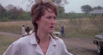 Movie still from “Silkwood” (1983), directed by Mike Nichols – A person wearing a white shirt; Close Up shot, Over the shoulder angle