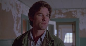 Movie still from “Silkwood” (1983), directed by Mike Nichols – A man in a green jacket looking to his left; Close Up shot, Low angle