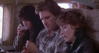 Movie still from “Silkwood” (1983), directed by Mike Nichols – A man and two women sitting next to each other on a bus; Medium shot, Low angle