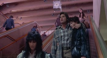 Movie still from “Silkwood” (1983), directed by Mike Nichols – A group of people standing next to each other in a room; Wide shot, Low angle