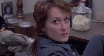 Movie still from “Silkwood” (1983), directed by Mike Nichols – A person sitting in front of a table; Close Up shot, High angle