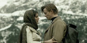 Movie still from “A Fortunate Man” (2018), directed by Bille August – A man and a woman standing next to each other; Close Up shot, Low angle