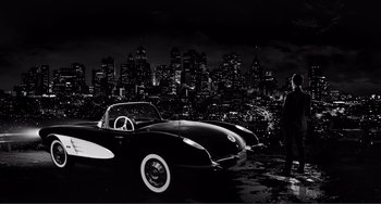 Movie still from “Sin City: A Dame to Kill For” (2014), directed by Frank Miller – A man standing in front of a car in a city at night; Wide shot, High angle