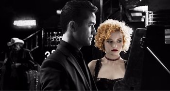 Movie still from “Sin City: A Dame to Kill For” (2014), directed by Frank Miller – A man and a woman standing next to each other; Close Up shot, Over the shoulder angle