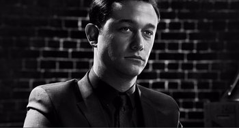 Movie still from “Sin City: A Dame to Kill For” (2014), directed by Frank Miller – Black and white photograph of a man wearing a suit and tie; Close Up shot, Low angle