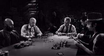 Movie still from “Sin City: A Dame to Kill For” (2014), directed by Frank Miller – A group of men sitting at a table playing poker; Wide shot, High angle