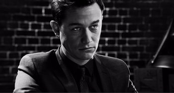 Movie still from “Sin City: A Dame to Kill For” (2014), directed by Frank Miller – Black and white photograph of a man in a suit and tie; Close Up shot, Low angle