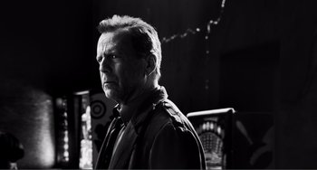 Movie still from “Sin City: A Dame to Kill For” (2014), directed by Frank Miller – Black and white photograph of a man looking at the camera; Close Up shot, Low angle