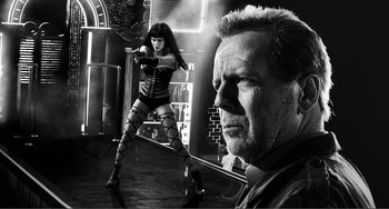 Movie still from “Sin City: A Dame to Kill For” (2014), directed by Frank Miller – Black and white photograph of a man and a woman; Medium shot, Low angle