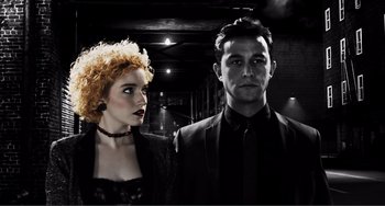 Movie still from “Sin City: A Dame to Kill For” (2014), directed by Frank Miller – A man and a woman standing next to each other; Close Up shot, Low angle