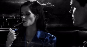 Movie still from “Sin City: A Dame to Kill For” (2014), directed by Frank Miller – A woman smoking a cigarette while sitting in a car; Close Up shot, Low angle