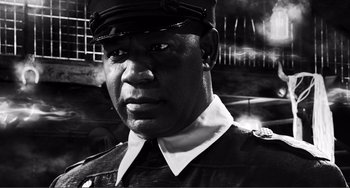 Movie still from “Sin City: A Dame to Kill For” (2014), directed by Frank Miller – A black and white photo of a man in a uniform; Close Up shot, Low angle